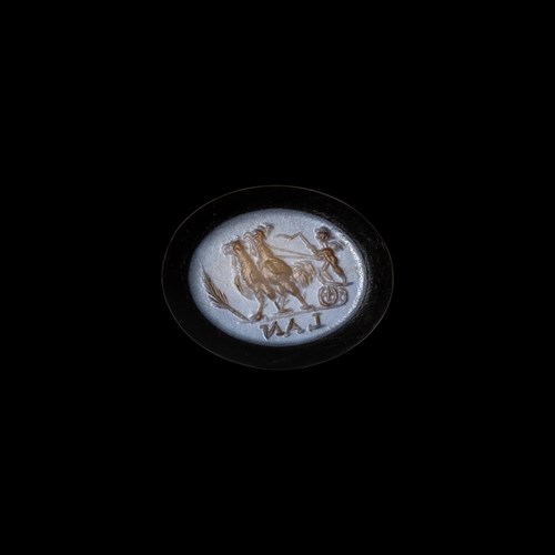 A Roman nicolo intaglio. Eros riding a chariot pulled by two roosters.